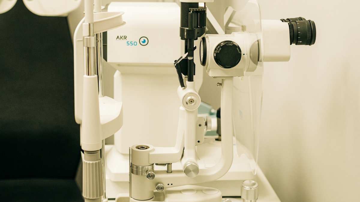 Modern ophthalmic diagnostic slit lamp and auto-kerato-refractometer in clean Madurai hospital examination room