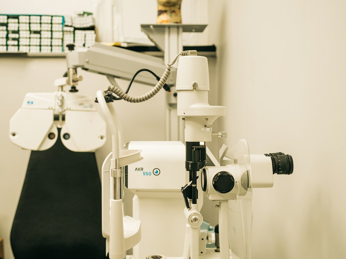 Modern ophthalmic treatment and examination room with diagnostic microscope and video monitors