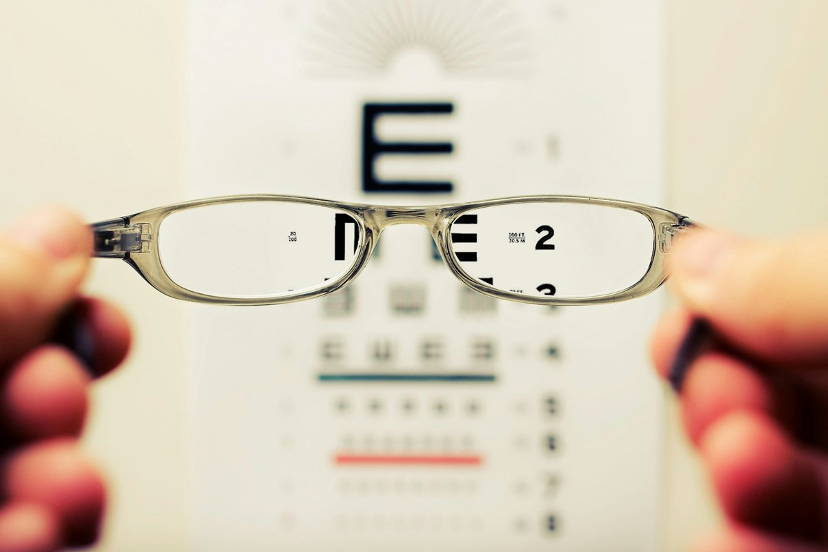 Optometrist fitting precision prescription eyeglasses and spectacle frames in optical dispensary