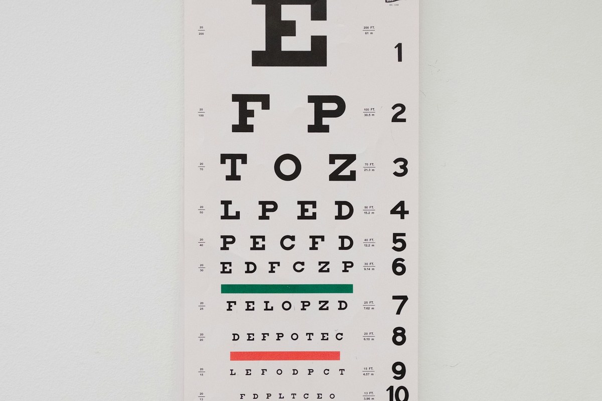 Ophthalmologist examining a patient's eyes using a precision slit lamp biomicroscope in examination room