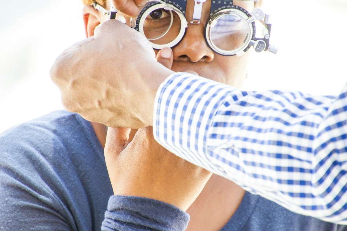 Ophthalmic specialist wearing surgical loupes conducting detailed clinical assessment